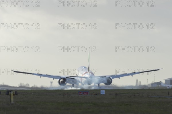 Boeing 777 commercial passenger airliner jet aircraft of Emirates airways landing on the runway at