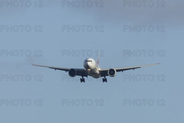 Boeing 777 commercial passenger airliner jet aircraft of Emirates airways in flight on approach to