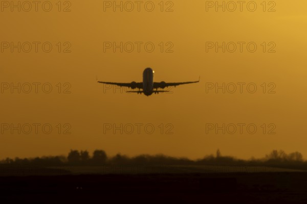 Airbus commercial passenger airliner jet aircraft taking off in flight at sunset at London Stansted