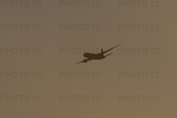 Boeing 777 A7-BFL commercial jet aircraft of Qatar cargo in flight silhouette at sunset at London