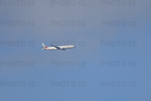 Boeing 777 commercial passenger airliner jet aircraft of Emirates airways in flight at London