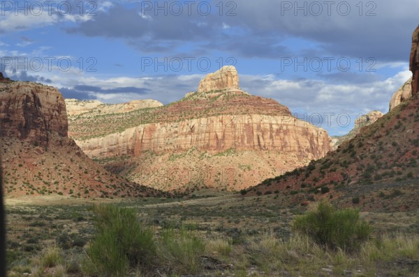 Beautiful rocky landscape under a blue sky with white clouds casting dramatic shadows, Canyonlands