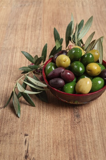 A mixture of olives, varieties of chalkidiki, Verdi giganti and Kalamata, in a bowl, top view, no
