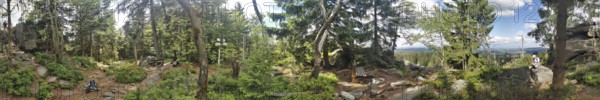 Panoramic view of a dense forest with trees and some rocks, Franconian mountain trail, hiking in