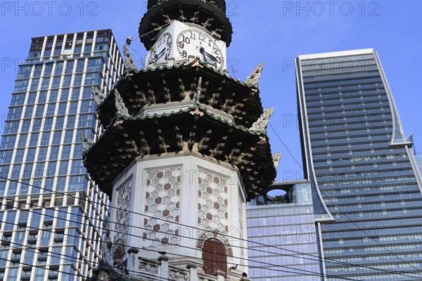 Bangkok, Thailand. March 4th 2025. The Chinese Clock Tower seen with the modern high rise buildings