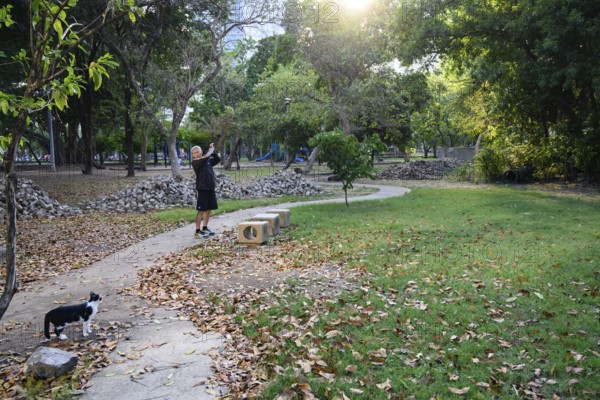 Bangkok, Thailand. March 4th 2025. A local man does some warm up stretches and exercises to keep