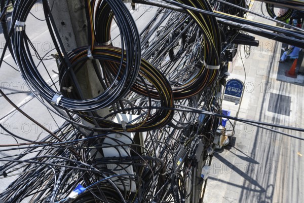 Bangkok, Thailand. March 4th 2025. A tangled mess of cables and wires used for phone and internet
