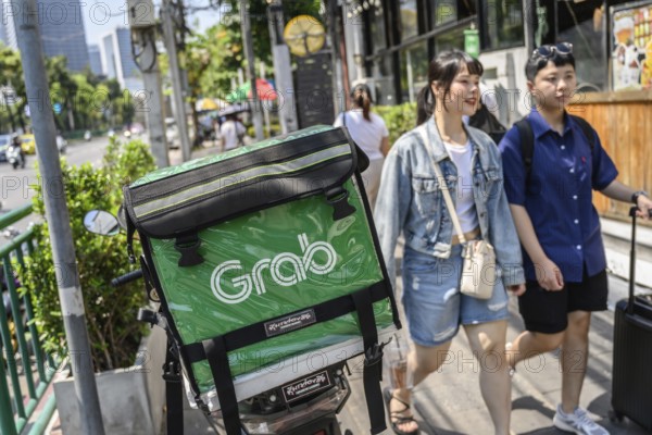 Bangkok, Thailand. March 25th 2025. Grab food delivery motorcycles parked in the busy streets of