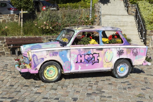 Colourfully painted and planted Trabant car on the old market in Hohenstein-Ernstthal, Saxony,