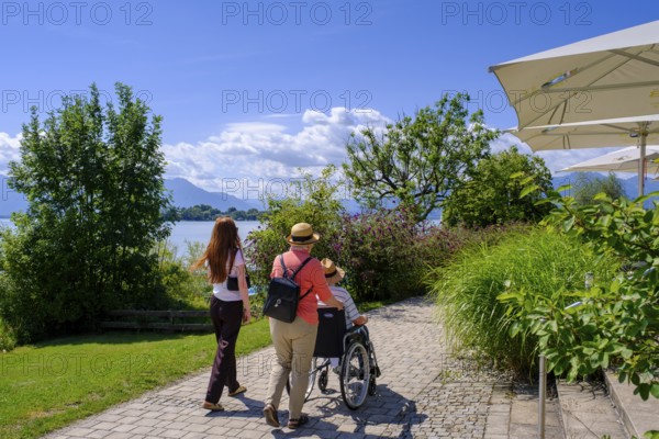 Walkers with wheelchair, Gstadt am Chiemsee, Chiemgau, Upper Bavaria, Bavaria, Germany