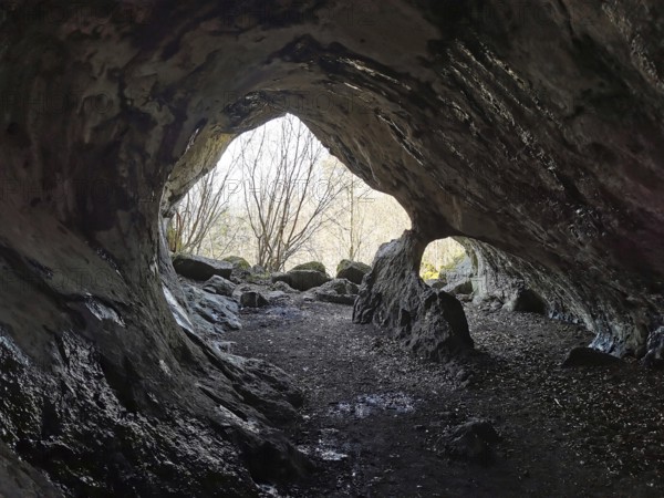 View from a mystical cave, with uneven rocks inside, Quack Castle, Franconian Switzerland, Upper