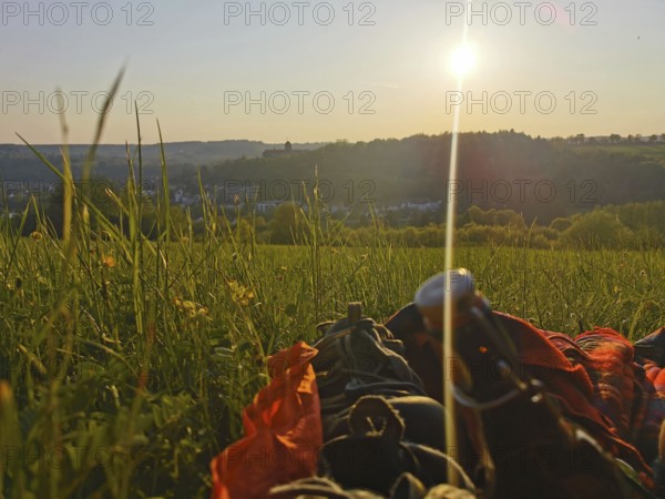 A picnic in a meadow as the sun sets and a panoramic view of the Rosenberg Fortress, Kronach,