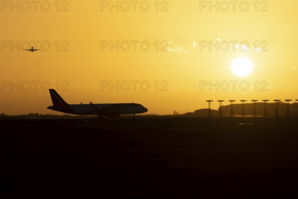 Airbus commercial passenger airliner jet aircraft taking off in flight with another plane on the