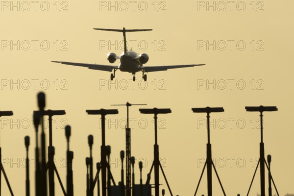 Cessna Citation small executive business jet aircraft in flight on approach to land over runway