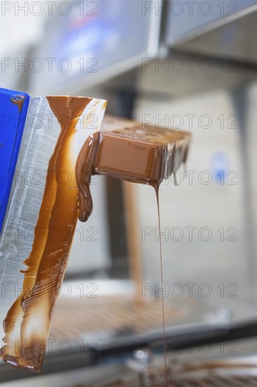 Flowing chocolate from a chocolate mold, vegan chocolates production, Haselstaller Hof, Gechingen,