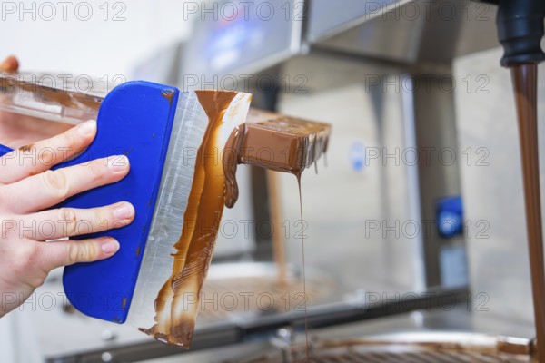 Side view of a flowing chocolate mold, vegan chocolates production, Haselstaller Hof, Gechingen,