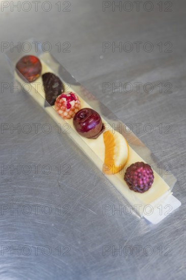 Various chocolates in a transparent gift box on a metal surface, Easter production of regional