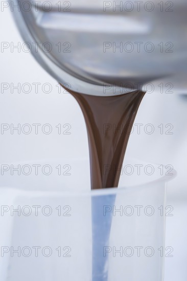 Liquid chocolate is poured into a container, Vegan Tart Production, Haselstaller Hof, Gechingen,