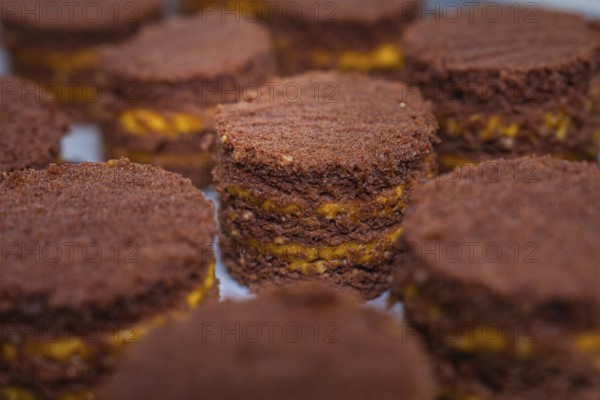 Close-up of small chocolate cakes with yellow layers, vegan cake production, Haselstaller Hof,