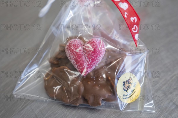 Chocolate snack with heart-shaped decoration in gift packaging, Easter production of regional