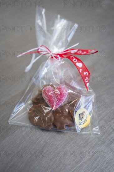 Chocolate snack with heart-shaped decoration in red gift packaging, Easter production of regional