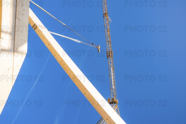 Construction elements in the foreground with a large crane, timber house construction, Gechingen,