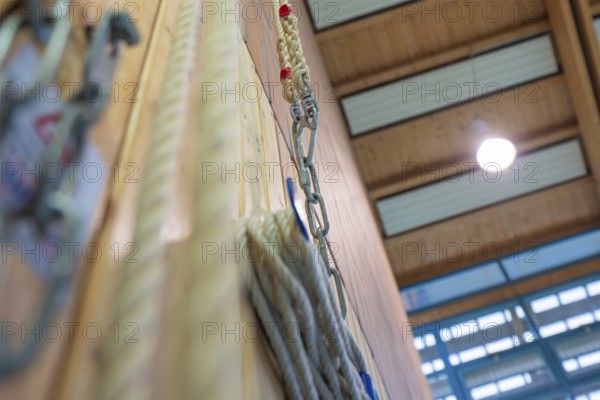 Rope suspension in a sports hall with wooden paneling and lamp light, Schlehengäu Sporthalle