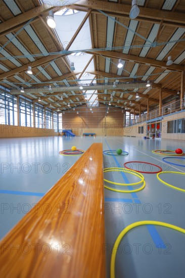 Tires lie on the floor of a gym next to a long wooden bench, Schlehengäu Sporthalle Gechingen, Calw
