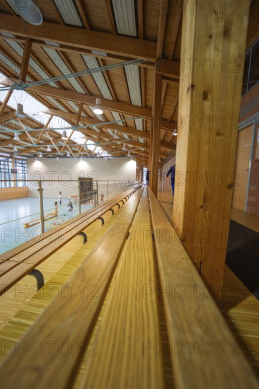 Elongated stand in a gym with participants doing sports activities, Schlehengäu Sporthalle