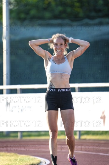 Woman smiling happily after a successful run on the track, middle distance runner Katharina Jaiser,