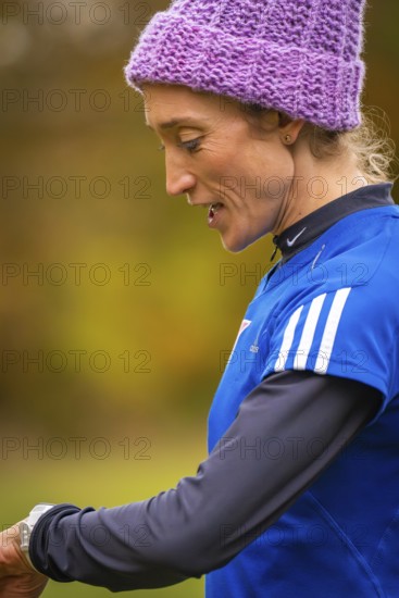 Close-up of a woman wearing sporty clothes, in an autumn setting, middle distance runner Katharina