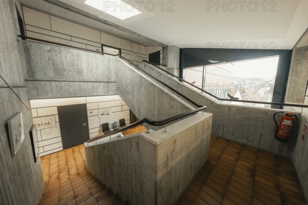 Functional staircase with concrete walls and skylight, minimalist aesthetics, Gechingen Town Hall,