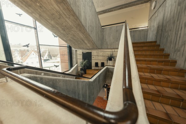 Modern staircase with concrete walls and windows, open architecture with city view, Gechingen Town