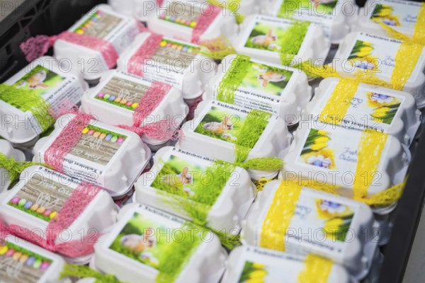 Decorated egg cartons with colorful ribbons and rabbit pictures on them, chocolate quail eggs,