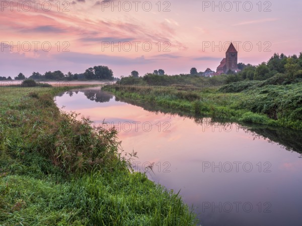 Tribsee with St. Thomas church on the river Trebel at dawn, North German brick Gothic, Peenetal