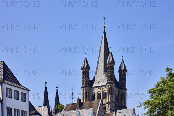 Church spire, steeples of Cologne Cathedral and Great St. Martin, gables, pointed roofs, trees,