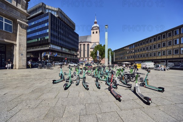 Traffic problem parked e-scooters in the city, general architecture, commercial building, modern