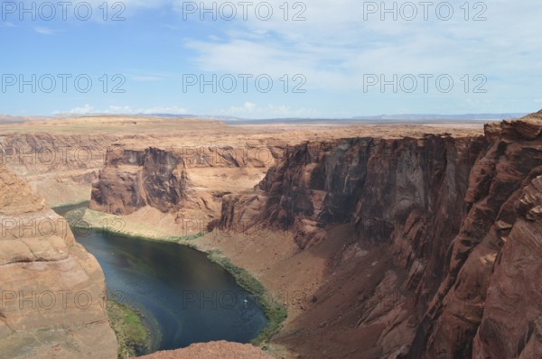 Red rock edges and a flowing river in the middle of the vast desert landscape, Horseshoe Bend,