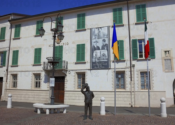 Italy, village of Brescello, the town hall, known from Don Camillo and Peppone, with a bronze