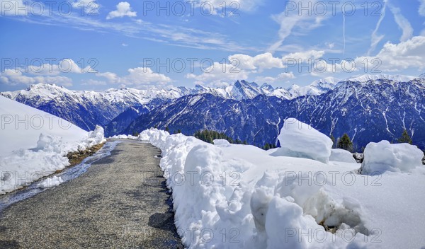 Alpine mountain landscape, hiking trail on the Fellhorn surrounded by snow with panoramic views of