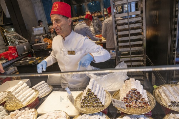 Istanbul, Turkey. December 2nd 2025. Turkish fez wearing staff inside Hafiz Mustafa baklava sweet