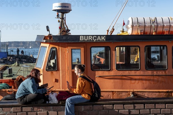 Canakkale, Turkey. February 18th 2022 Two young Turkish girls hanging out on the seafront of