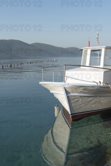 Stunning view of a boat moored in the beautiful harbour of Turkish Riviera seaside town of Akyaka