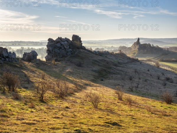 Rock formations in the Teufelsmauer nature reserve in morning light and morning fog, near