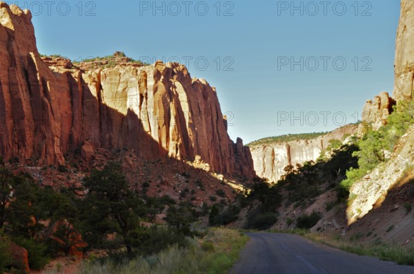 Tall rocks frame a road leading through a dramatic canyon landscape, Grand Staircase Escalante