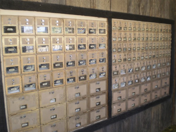 Interior view of many mailboxes in a post office building with wooden surroundings, Henrieville