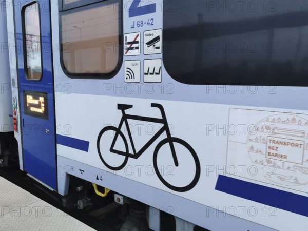 Side view of a train with bicycle symbol and blue paint, Polish bicycle compartment, cycling in