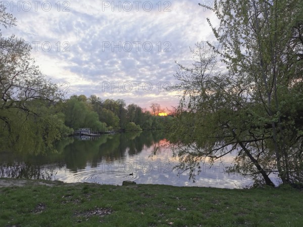 Sunset at Weissensee in Berlin with reflecting water, Pankow, Berlin