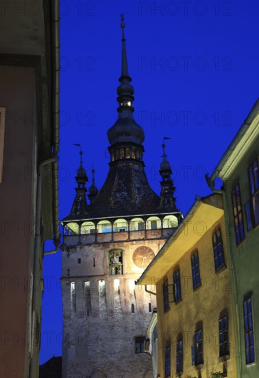 Romania, hour tower at the blue hour in the historic old town of Sighisoara, German Sighisoara,