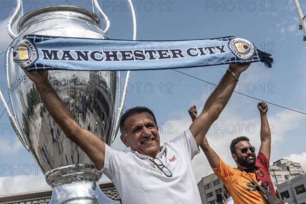 Istanbul, Turkey. June 9th 2023 A Manchester City football fan poses with a scarf in Taksim Square